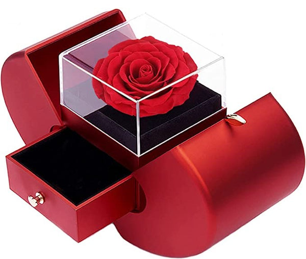 Caja de regalo de corazón con rosa real.